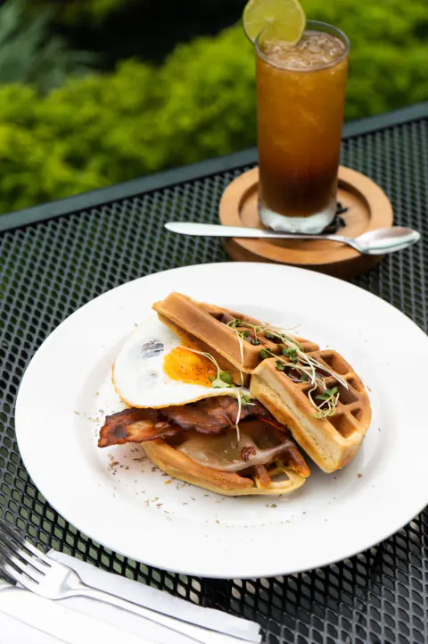 Waffle con huevo y tocineta en la terraza